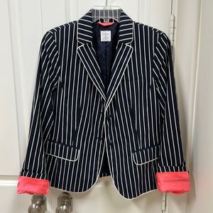Black and white striped blazer with hot pink coral accents.